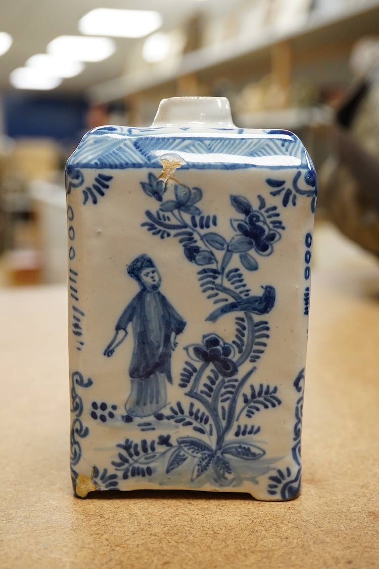 An 18th century Delft tea caddy decorated with figures and flowers and tile, 13cm square